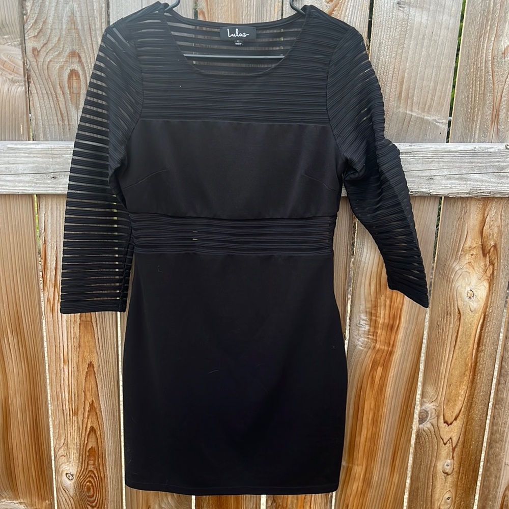 Black dress with three-quarter length sleeves
